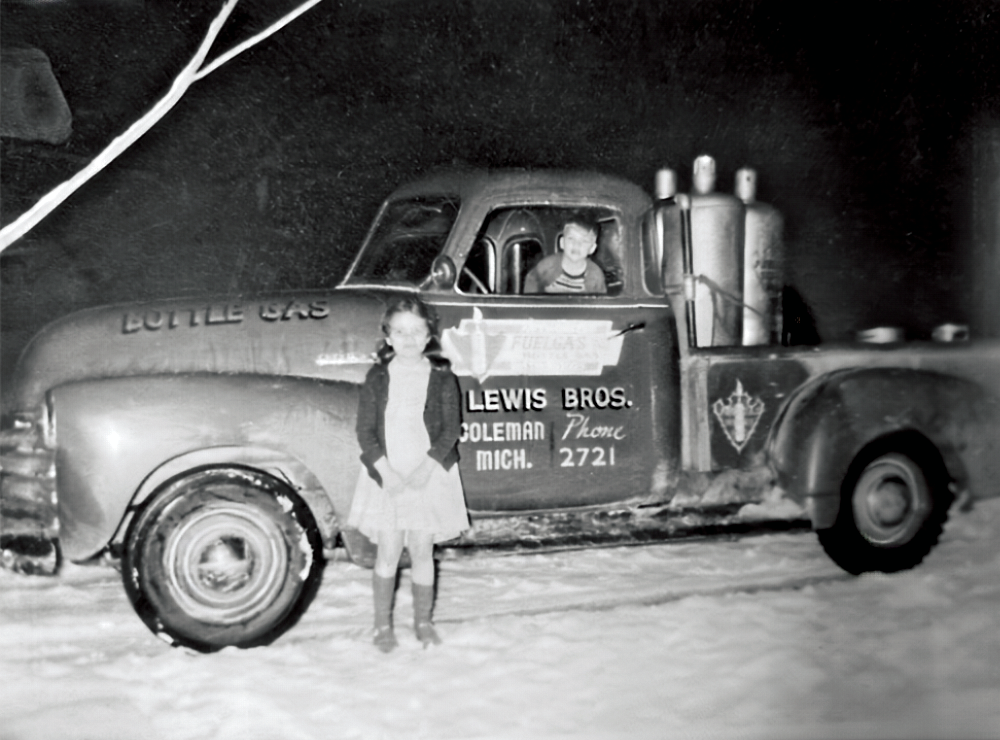 Vintage Lewis Bros bottle gas truck from Coleman, Michigan, parked in the snow